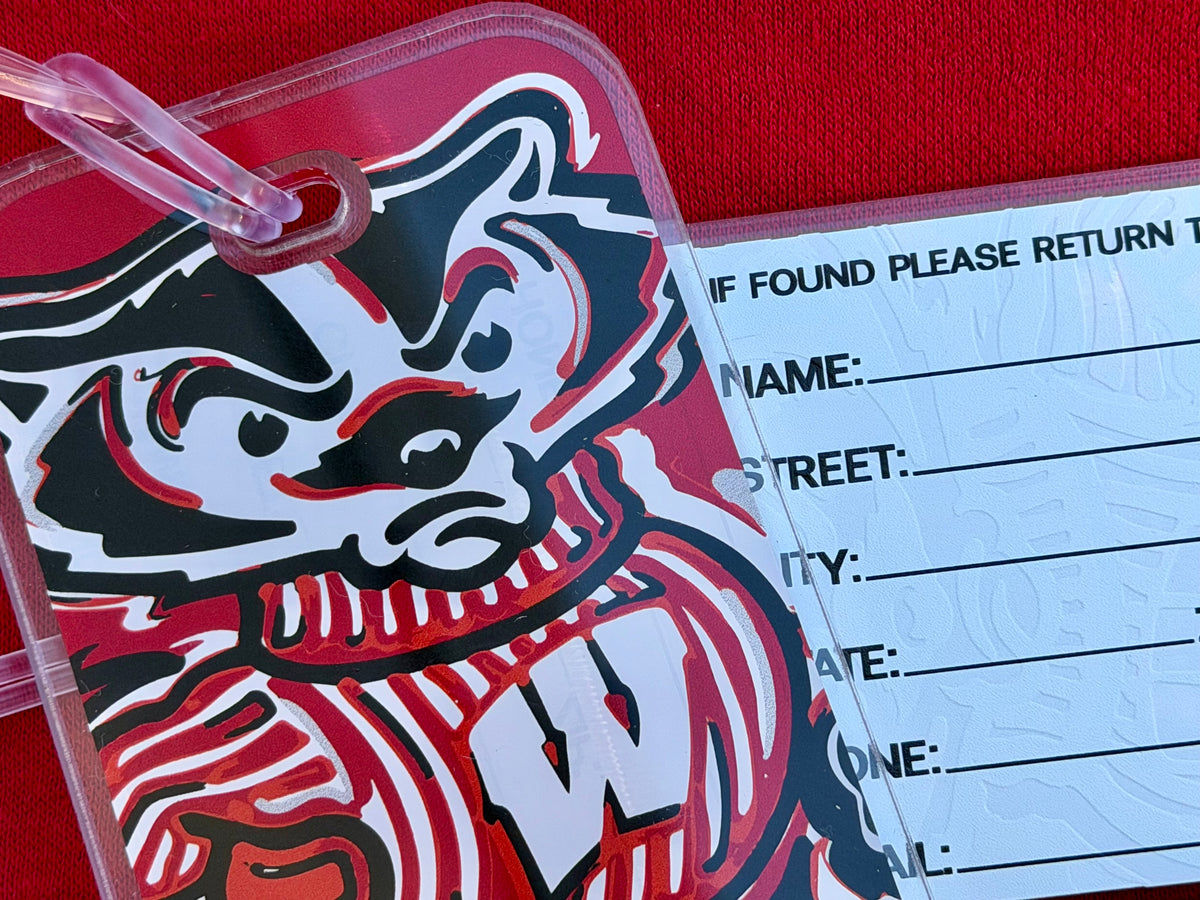 Bucky Badger luggage tag with clear frame and pink strap, bold mascot graphic