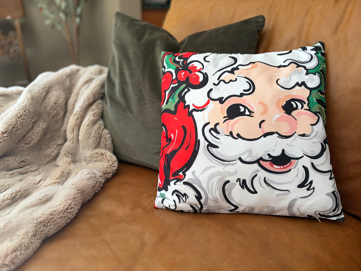 Santa-themed square throw pillow with Santa face print and dark green backing