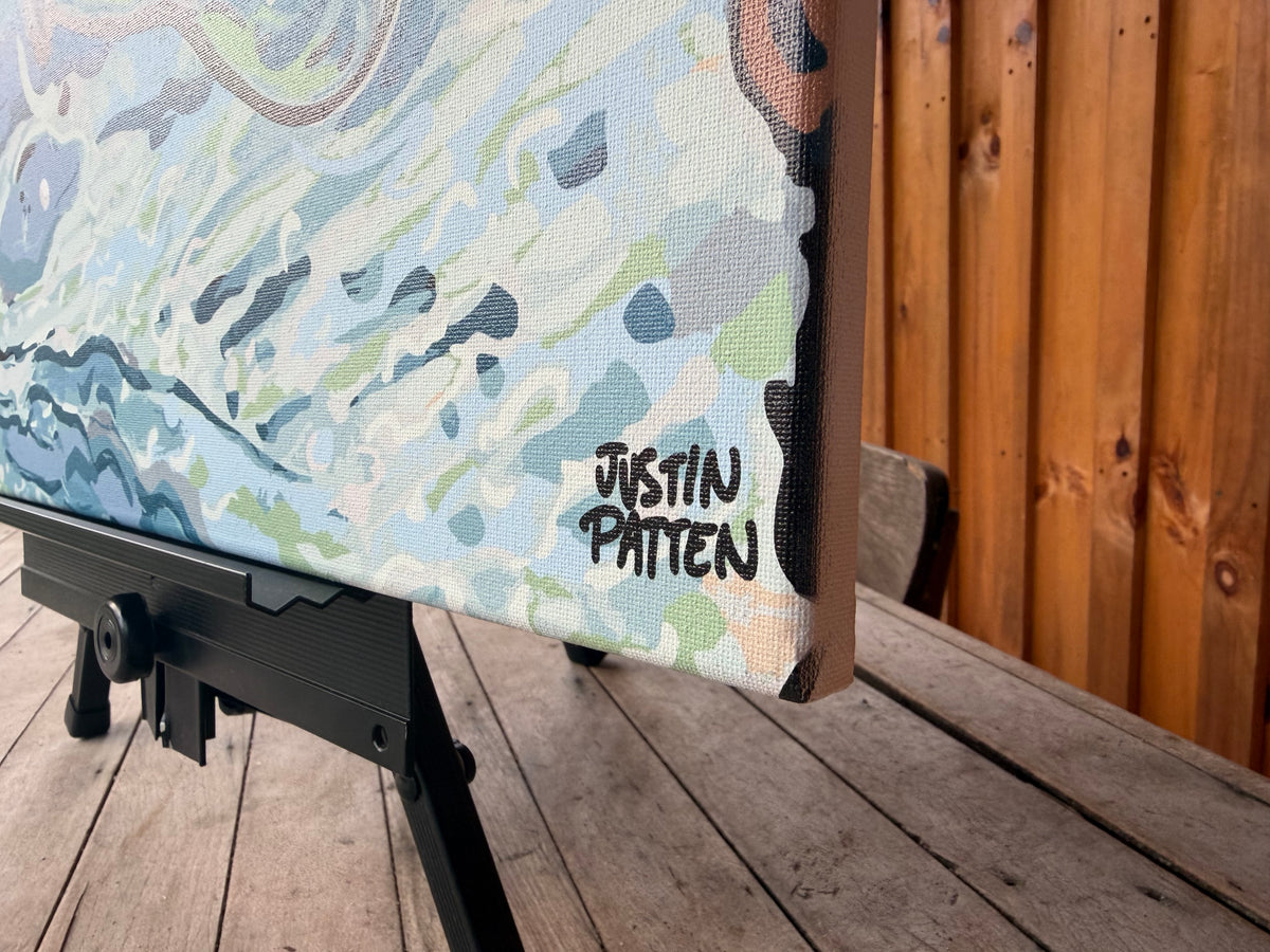 Wrapped canvas print detail showing the artist's signature and painted water