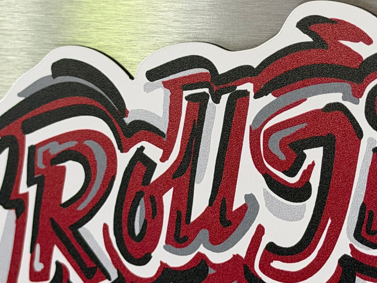 Close-up of the red, black and white lettering on the University of Alabama magnet