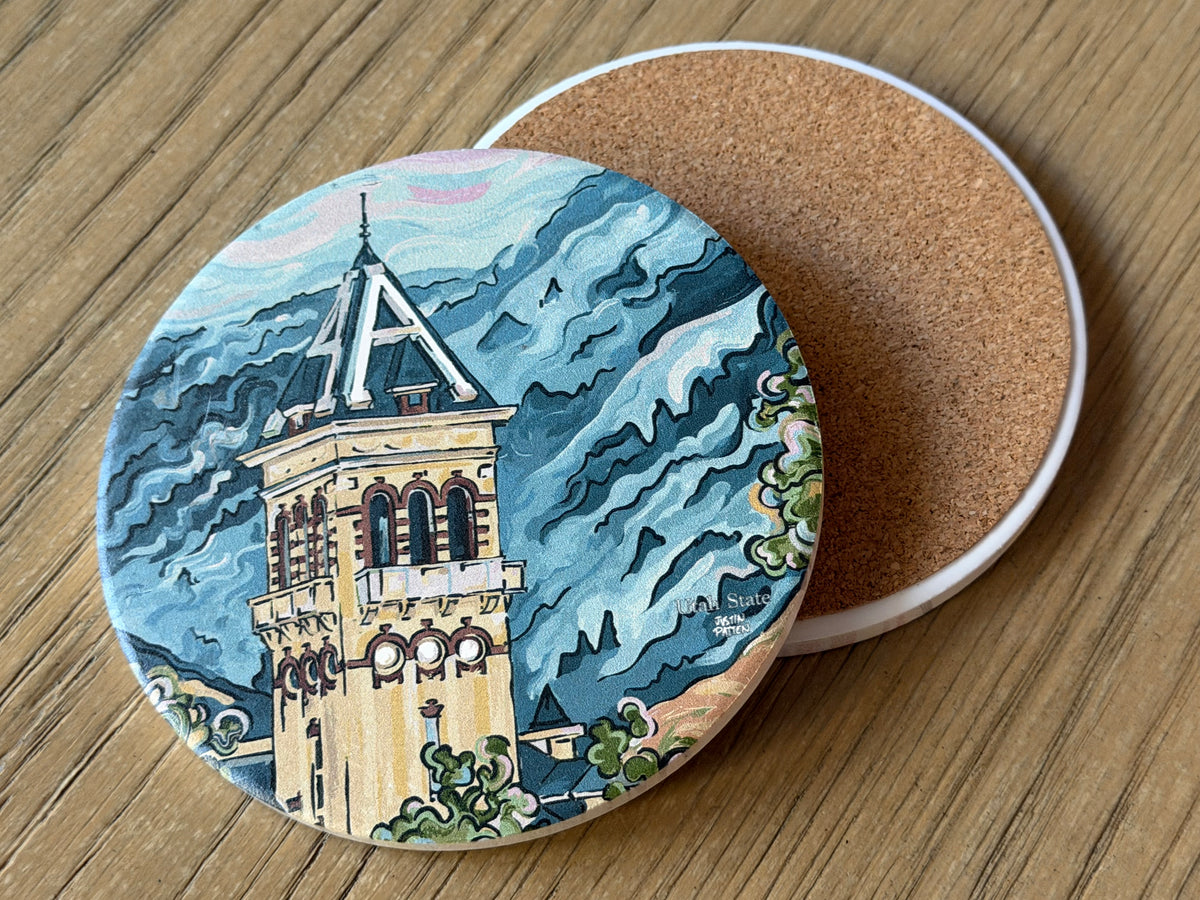 Round stone coaster with illustrated university building and blue wave background