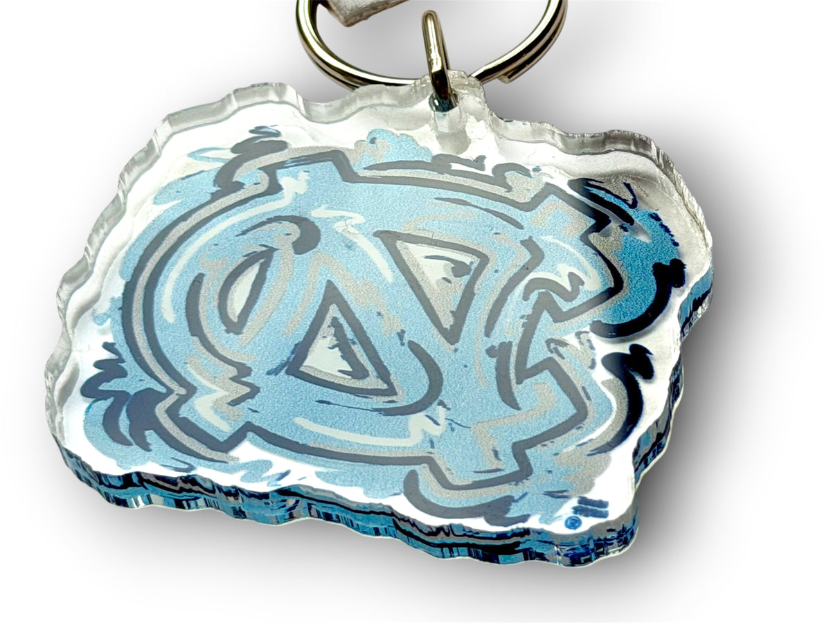 University of North Carolina keychain showing its thick, layered edge and blue NC logo