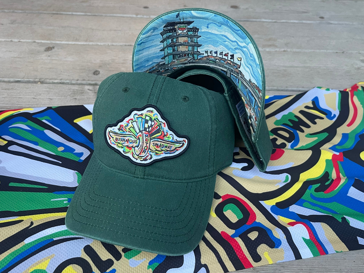 Alpine green dad hat with embroidered racing logo patch on the front panel