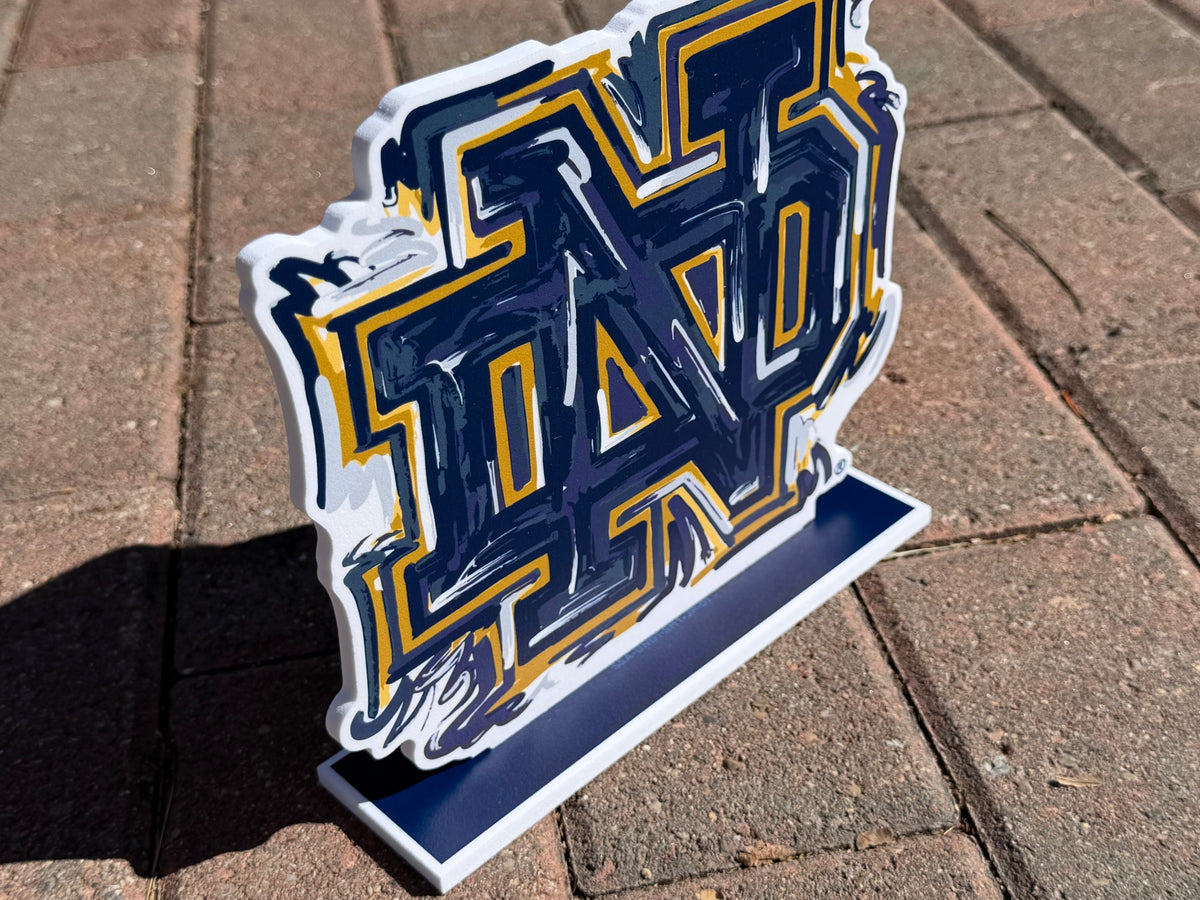 Notre Dame ND standee with blue and gold block letters on white base