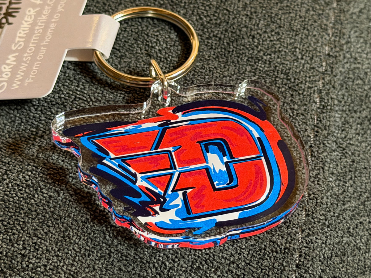 Sports keychain with colorful 'D' logo charm and metal key ring