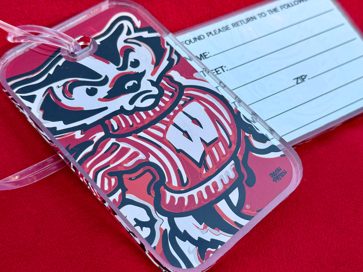 Bucky Badger luggage tag with clear frame and pink strap, mascot print and label pocket