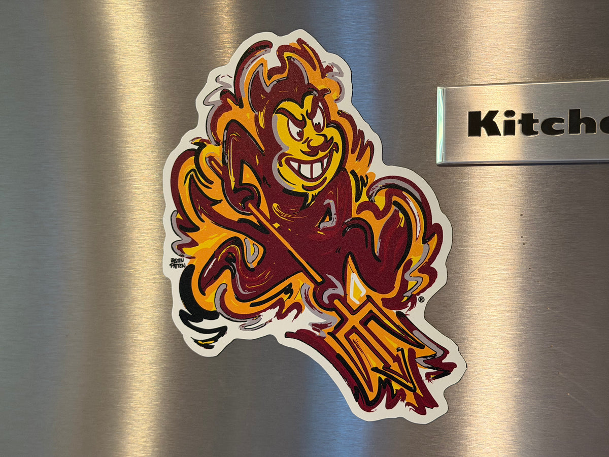 Sun devil mascot magnet with sword, orange and maroon tones and white outline
