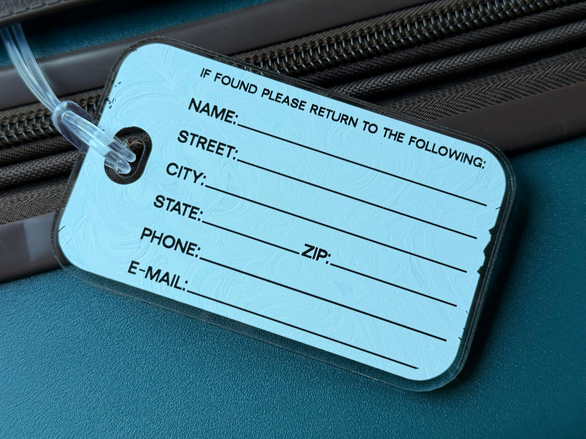 Mascot bag tag with printed return information lines and blue string