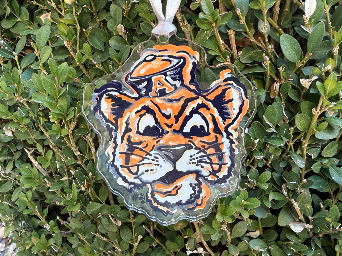 Auburn University Aubie ornament with a white hanging ribbon and detailed tiger face.