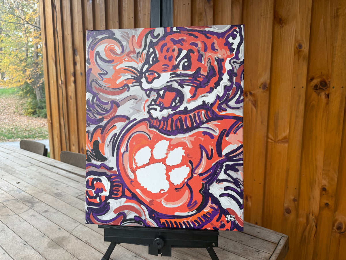 Clemson University wrapped canvas print featuring a roaring tiger and paw in orange, purple, and white