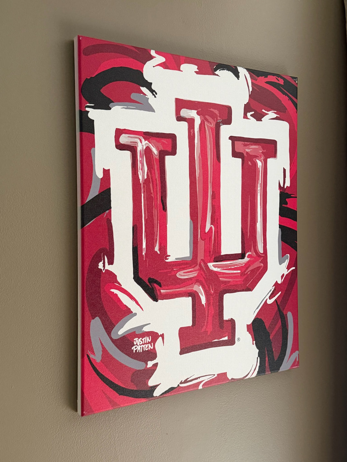 Wrapped canvas print featuring centered red-and-white IU trident emblem on stretched canvas