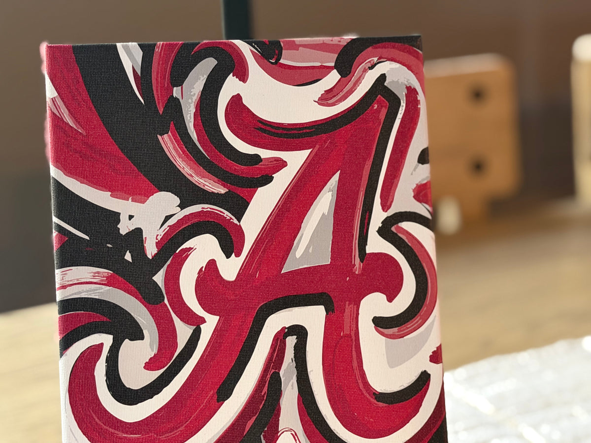 Wrapped canvas print close-up with bold red, white, and black lettered swirls