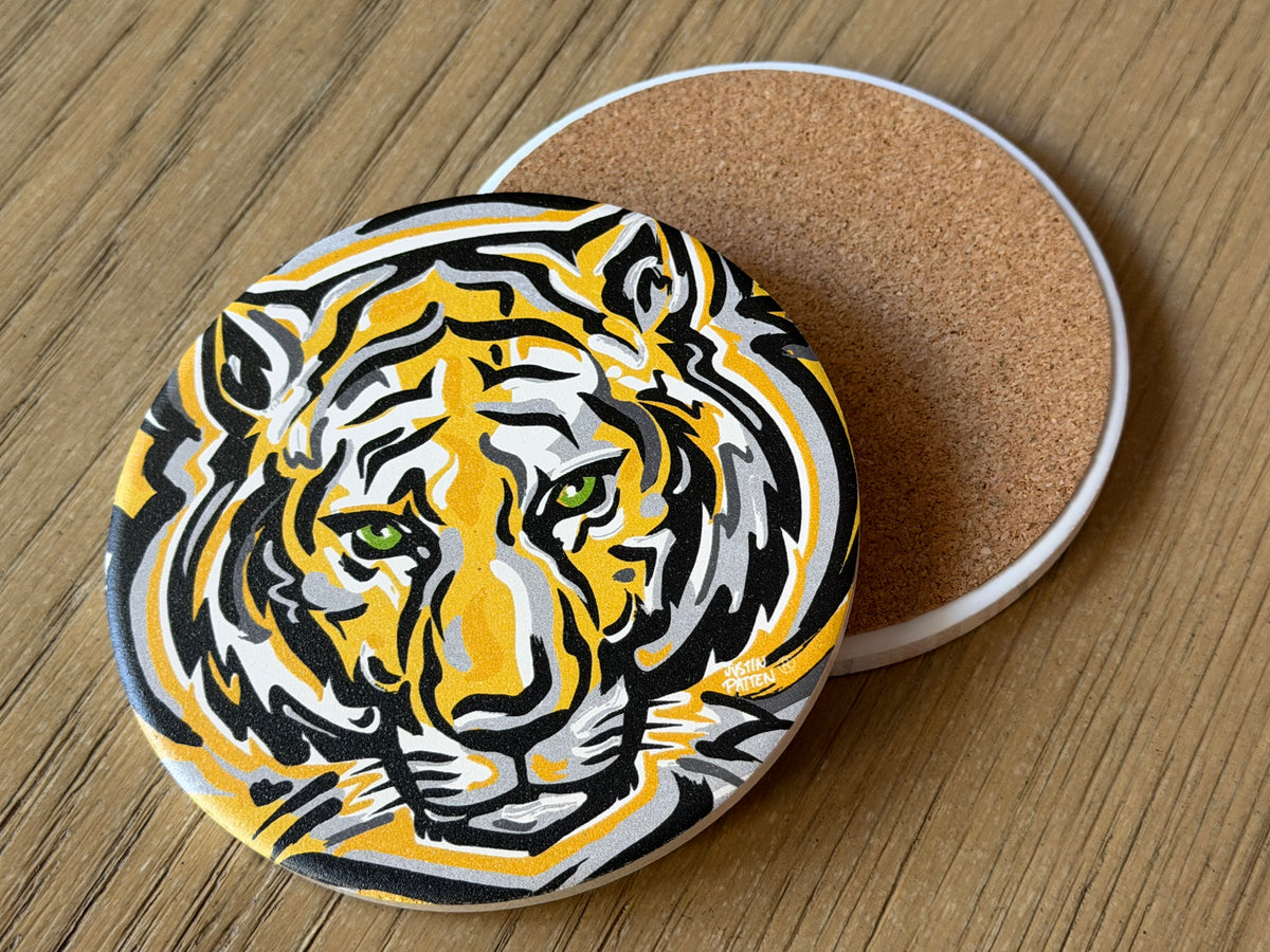 Round tiger face coaster with cork backing visible on the side