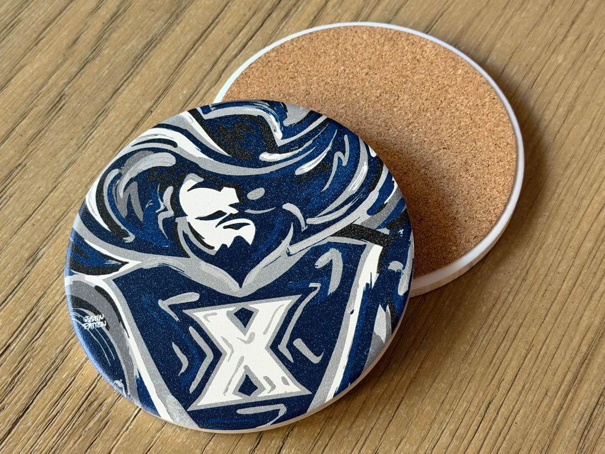 Round coaster with blue and white mascot graphic and cork underside edge