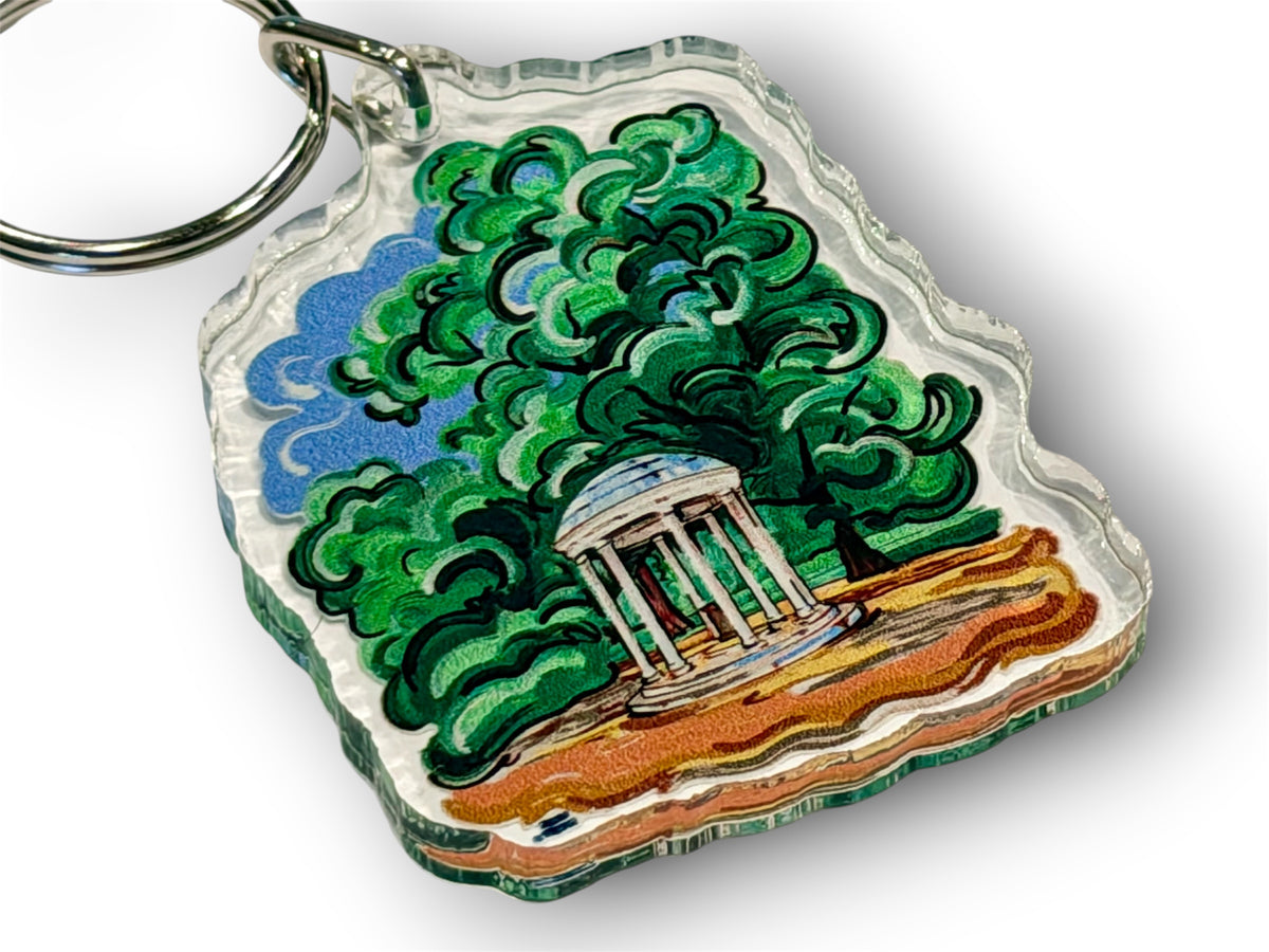 Acrylic Old Well keychain showing a white pavilion among green trees